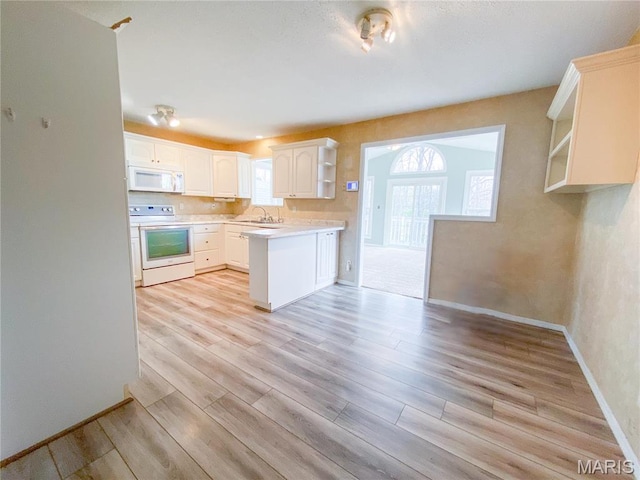 19113 Bent Oak Dr, Warrenton, MO 63383 - kitchen featuring white appliances, open shelves, light wood-style flooring, and healthy amount of natural light