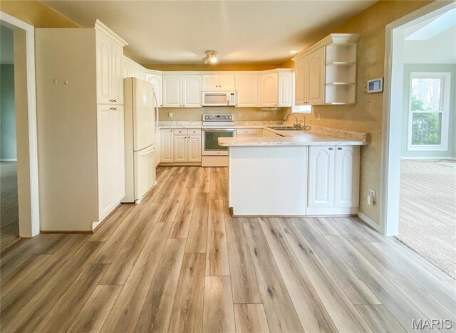 19113 Bent Oak Dr, Warrenton, MO 63383 - kitchen with white appliances, a peninsula, light wood-type flooring, light countertops, and open shelves