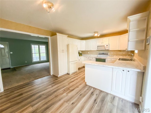 19113 Bent Oak Dr, Warrenton, MO 63383 - kitchen with white appliances, a peninsula, light countertops, light wood-type flooring, and open shelves