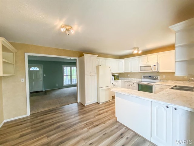 19113 Bent Oak Dr, Warrenton, MO 63383 - kitchen with white appliances, open shelves, a peninsula, light wood finished floors, and white cabinets