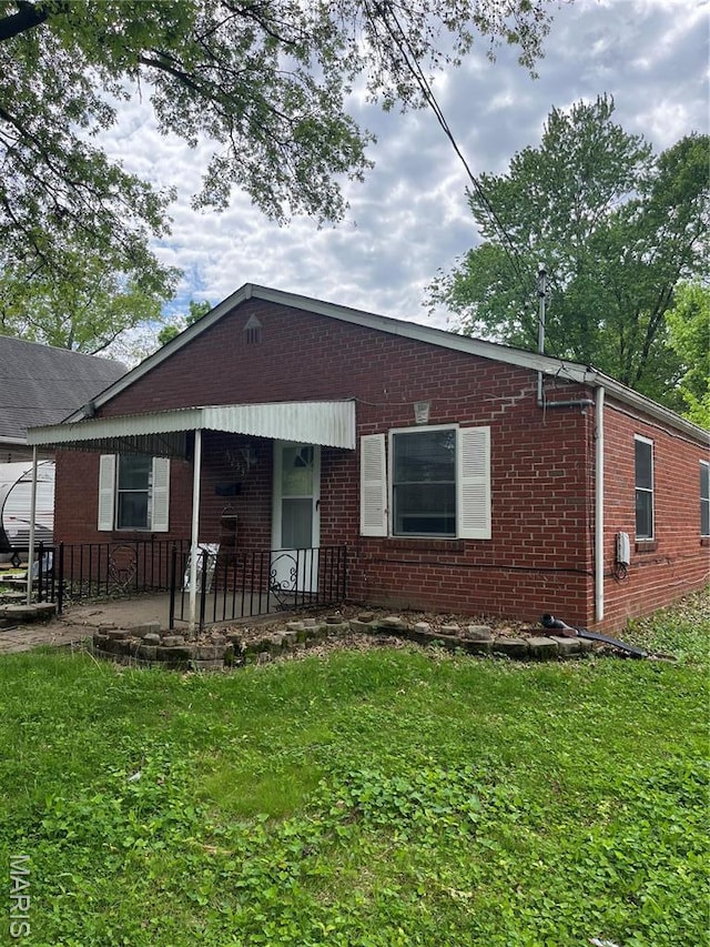 3253 Coles Ave, Saint Louis, MO 63114 - view of front facade with a front yard and brick siding