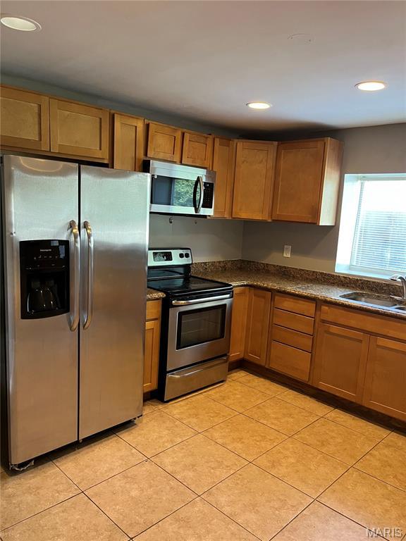 3253 Coles Ave, Saint Louis, MO 63114 - kitchen featuring appliances with stainless steel finishes, a sink, dark countertops, recessed lighting, and light tile patterned floors