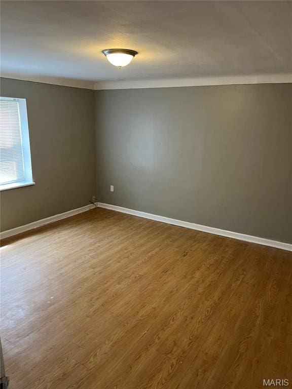 3253 Coles Ave, Saint Louis, MO 63114 - spare room with baseboards and dark wood-type flooring
