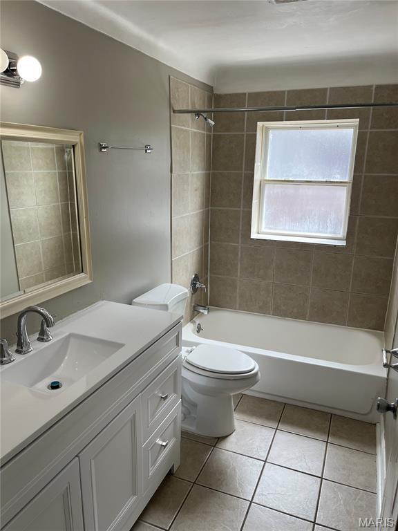3253 Coles Ave, Saint Louis, MO 63114 - full bathroom with tile patterned flooring, vanity, toilet, and bathing tub / shower combination
