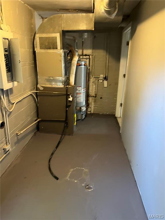 3253 Coles Ave, Saint Louis, MO 63114 - basement with water heater, electric panel, concrete block wall, and heating unit