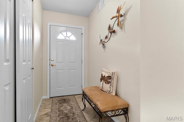 doorway to outside featuring light marble finish floors and baseboards