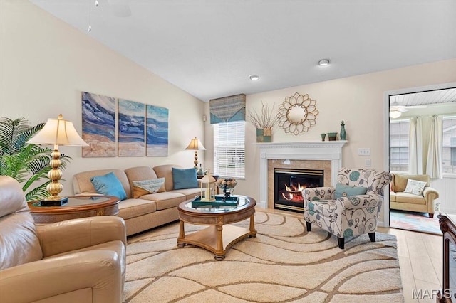living area with a premium fireplace, wood finished floors, vaulted ceiling, and recessed lighting