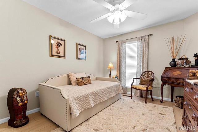 bedroom with baseboards, wood finished floors, and ceiling fan