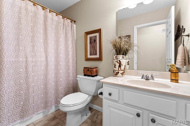 bathroom with toilet, vanity, tile patterned flooring, and curtained shower