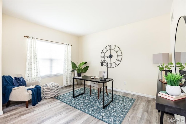 office space with wood finished floors and baseboards
