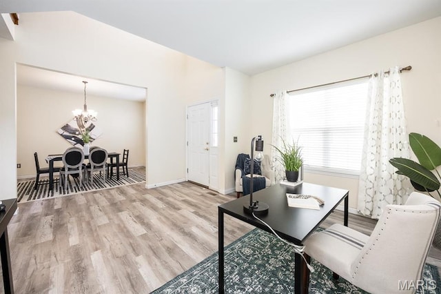 office area with wood finished floors, a chandelier, and baseboards