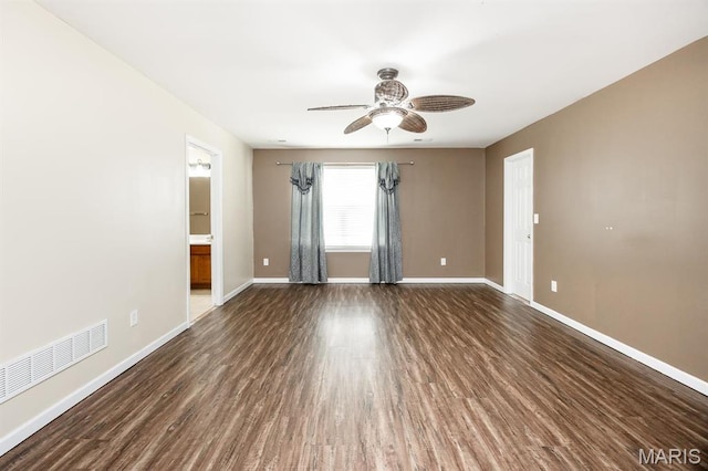 unfurnished room featuring a ceiling fan, baseboards, and wood finished floors
