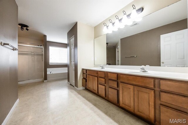 full bath with double vanity, a shower stall, a bath, baseboards, and tile patterned floors