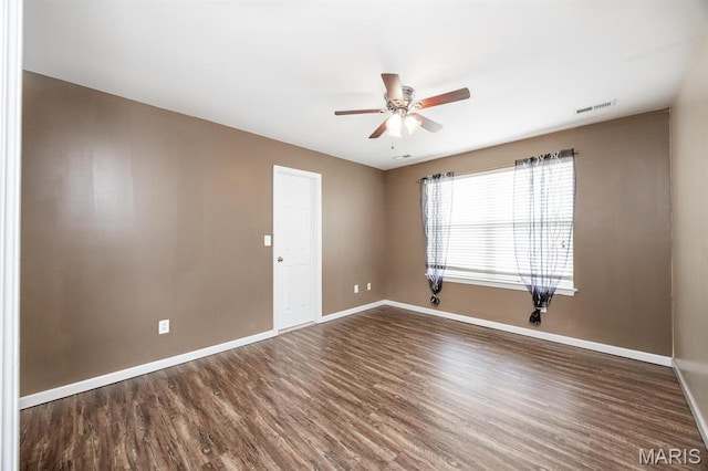 unfurnished room with ceiling fan, baseboards, and wood finished floors