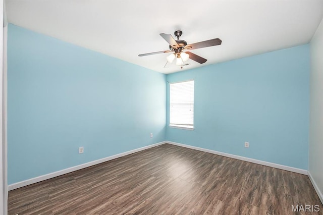 empty room with dark wood-style floors, baseboards, and ceiling fan