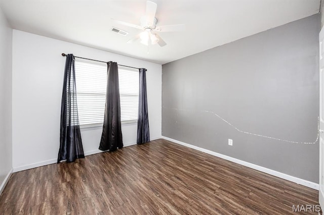 empty room featuring a ceiling fan, baseboards, and wood finished floors