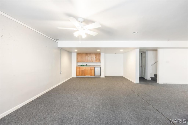 unfurnished living room featuring ceiling fan, stairway, baseboards, recessed lighting, and a sink