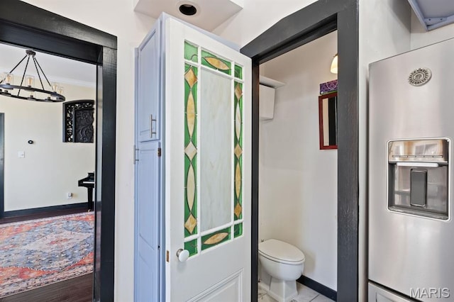 921 Morrison Ave, Saint Louis, MO 63104 - bathroom with baseboards, toilet, and a chandelier