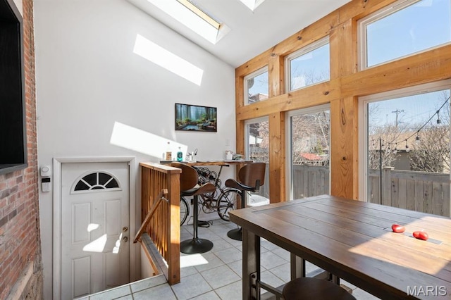 921 Morrison Ave, Saint Louis, MO 63104 - dining area featuring a skylight, high vaulted ceiling, and light tile patterned flooring