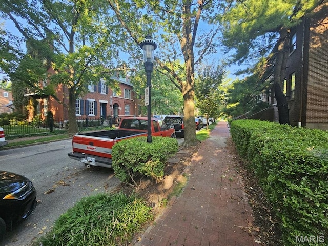 921 Morrison Ave, Saint Louis, MO 63104 - view of asphalt road with street lighting, sidewalks, and curbs