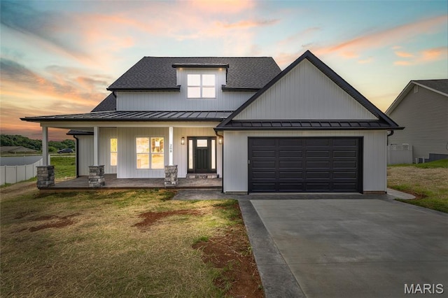 208 Ariel Ct, Desloge, MO 63601 - modern farmhouse style home with a standing seam roof, covered porch, driveway, a lawn, and an attached garage