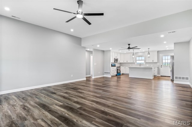 208 Ariel Ct, Desloge, MO 63601 - unfurnished living room featuring ceiling fan, recessed lighting, dark wood-style flooring, baseboards, and a sink