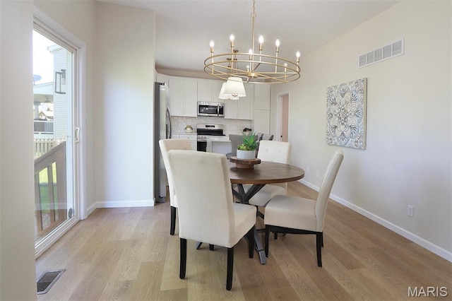 1739 Naughton Way, Swansea, IL 62226 - dining room with a chandelier, light wood-style flooring, and baseboards