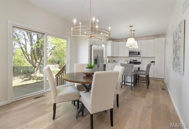 1739 Naughton Way, Swansea, IL 62226 - dining room featuring a chandelier, light wood finished floors, and baseboards