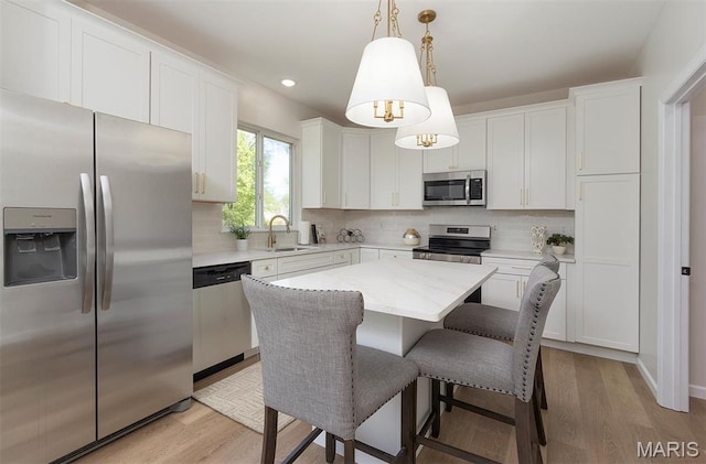 1739 Naughton Way, Swansea, IL 62226 - kitchen featuring appliances with stainless steel finishes, a sink, light wood-style flooring, backsplash, and recessed lighting