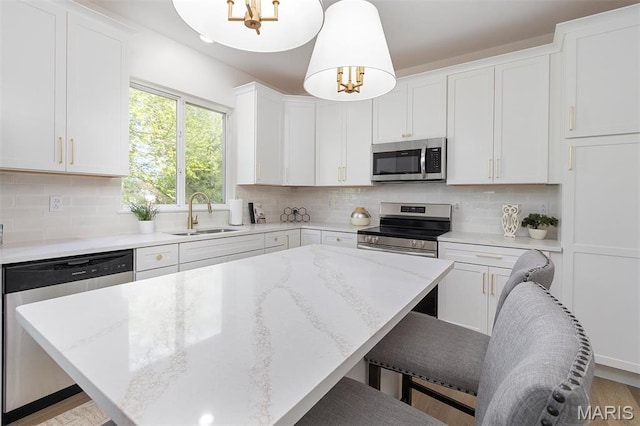 1739 Naughton Way, Swansea, IL 62226 - kitchen featuring appliances with stainless steel finishes, a sink, tasteful backsplash, and white cabinetry