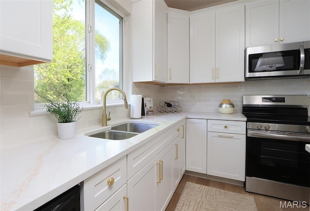 1739 Naughton Way, Swansea, IL 62226 - kitchen featuring stainless steel appliances, a sink, white cabinetry, backsplash, and wood finished floors