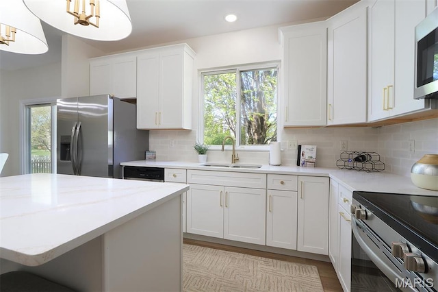 1739 Naughton Way, Swansea, IL 62226 - kitchen with appliances with stainless steel finishes, a sink, healthy amount of natural light, white cabinetry, and recessed lighting