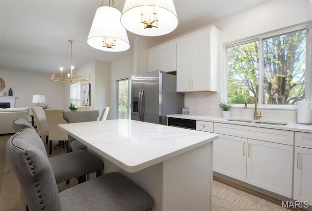 1739 Naughton Way, Swansea, IL 62226 - kitchen featuring a sink, a chandelier, stainless steel fridge with ice dispenser, a kitchen bar, and a center island
