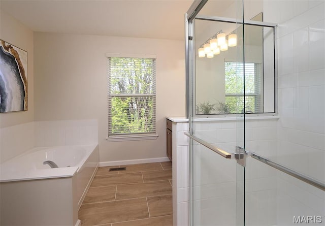1739 Naughton Way, Swansea, IL 62226 - full bathroom with a shower stall, a garden tub, and baseboards