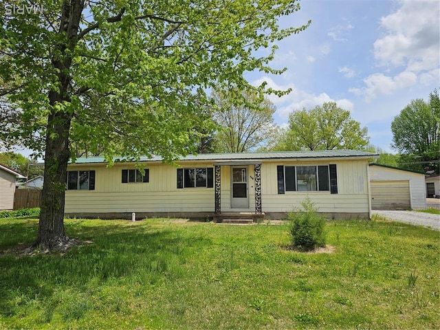 700 N James St, Sparta, IL 62286 - single story home with a front yard, metal roof, a detached garage, and board and batten siding