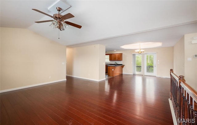 19252 Lambert Ln, Waynesville, MO 65583 - unfurnished living room featuring ceiling fan, dark wood-style flooring, a chandelier, baseboards, and vaulted ceiling