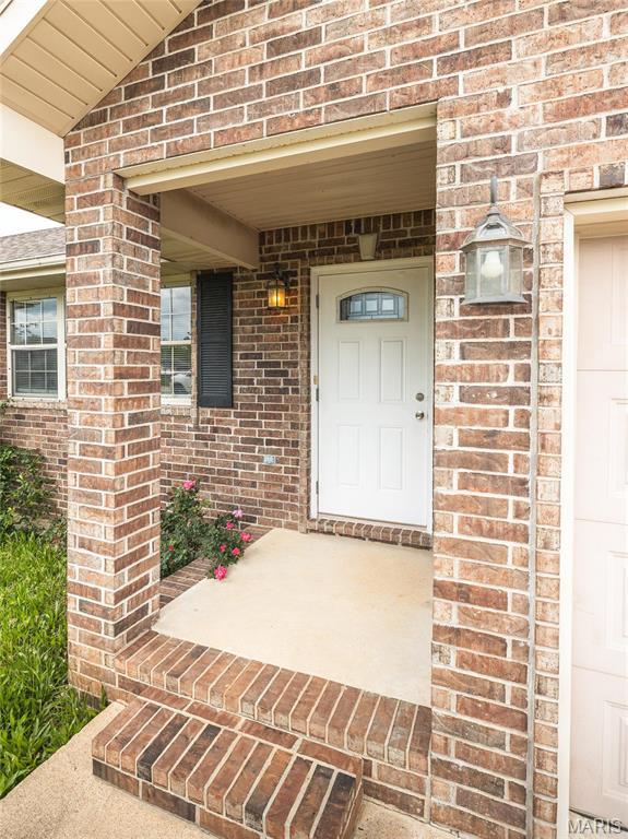19252 Lambert Ln, Waynesville, MO 65583 - view of exterior entry featuring brick siding and covered porch