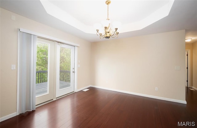 19252 Lambert Ln, Waynesville, MO 65583 - empty room with a chandelier, dark wood finished floors, and baseboards