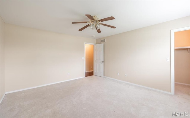 19252 Lambert Ln, Waynesville, MO 65583 - unfurnished bedroom featuring a spacious closet, carpet, baseboards, a closet, and a ceiling fan