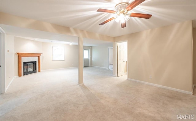 19252 Lambert Ln, Waynesville, MO 65583 - basement with light colored carpet, a ceiling fan, a glass covered fireplace, and baseboards