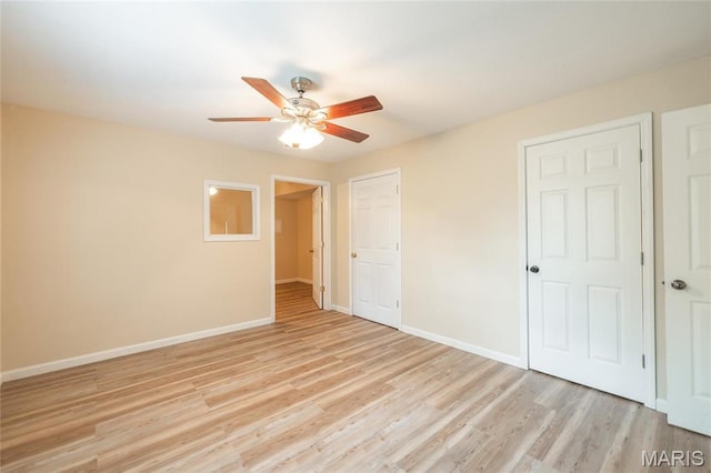 19252 Lambert Ln, Waynesville, MO 65583 - unfurnished bedroom featuring baseboards, light wood-style floors, and a ceiling fan