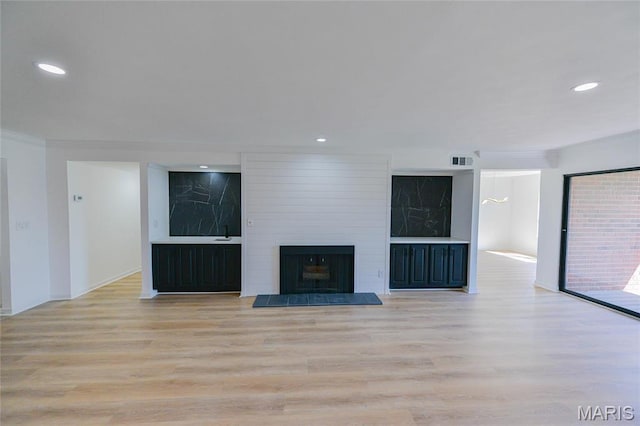 590 Sarah Ln Unit 303, Saint Louis, MO 63141 - unfurnished living room with light wood-type flooring, a fireplace, recessed lighting, baseboards, and crown molding