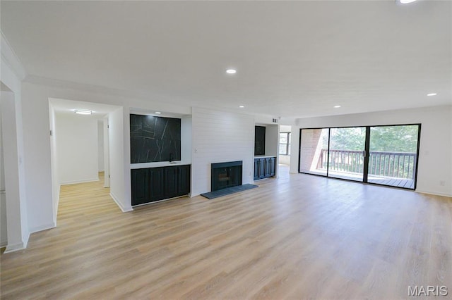 590 Sarah Ln Unit 303, Saint Louis, MO 63141 - unfurnished living room featuring light wood-style floors, baseboards, a large fireplace, and recessed lighting