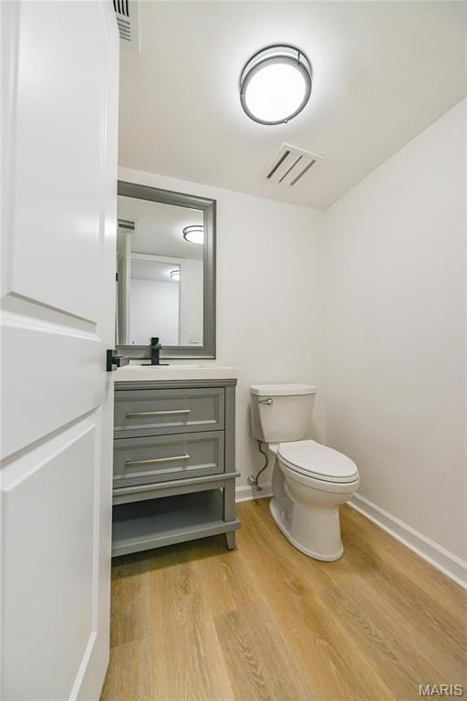 590 Sarah Ln Unit 303, Saint Louis, MO 63141 - bathroom featuring wood finished floors, toilet, vanity, and baseboards