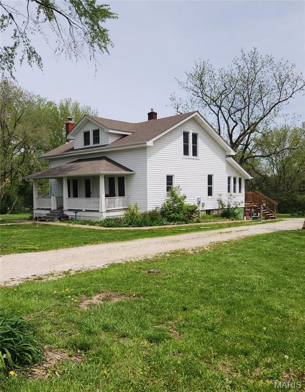 114 S Water St, Truesdale, MO 63380 - view of front of house featuring a chimney, covered porch, and a front lawn