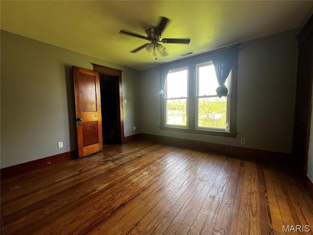 114 S Water St, Truesdale, MO 63380 - unfurnished bedroom featuring dark wood finished floors, baseboards, and ceiling fan