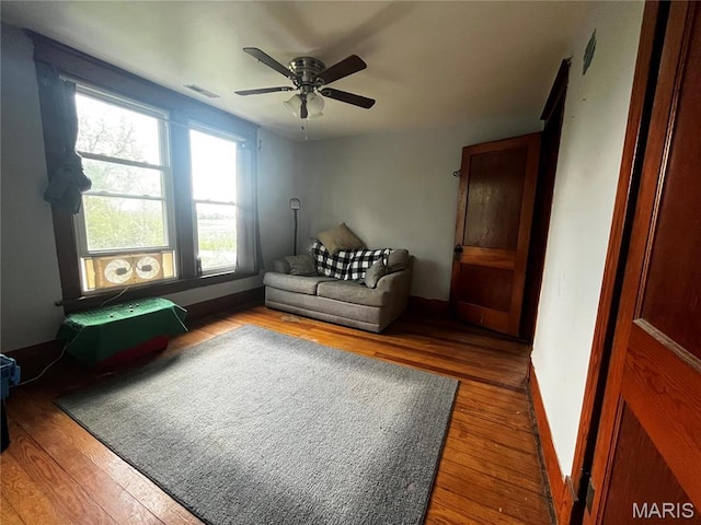 114 S Water St, Truesdale, MO 63380 - living room featuring wood finished floors, ceiling fan, and baseboards
