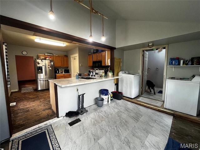 114 S Water St, Truesdale, MO 63380 - kitchen with stainless steel fridge, brown cabinetry, black microwave, a peninsula, and light countertops
