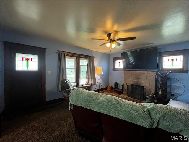 114 S Water St, Truesdale, MO 63380 - living area with a fireplace, plenty of natural light, a ceiling fan, and dark carpet