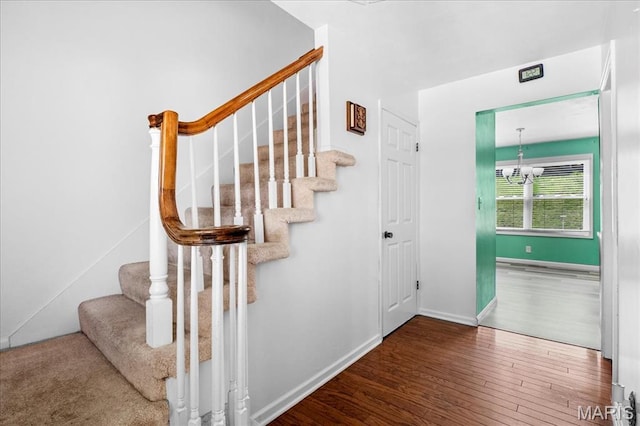 27 Heatherwood Dr, Collinsville, IL 62234 - staircase with wood finished floors, a chandelier, and baseboards